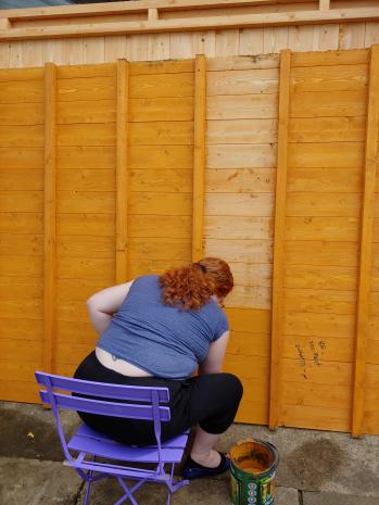 My wife painting the underside of the shed base