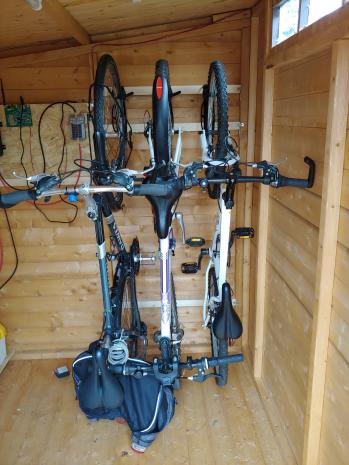 Three bikes hanging in the shed